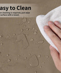 Close-up of cleaning patio heater cover with towel, water droplets visible, showcasing Patio Heater Cover With Zipper And Storage Bag All Weather Waterproof Dustproof UV Protected Wind Resistant Fits Most Propane Patio Heaters Camel 89 Inches High 33 Inches Diameter 19 Inches Base durability.