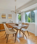 Montreal 29 Inch Six Light French Country Chandelier with Adjustable Height in smoked birch finish over dining table in bright room