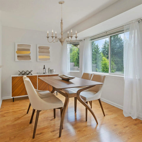 Montreal 29 Inch Six Light French Country Chandelier with Adjustable Height in smoked birch finish over dining table in bright room
