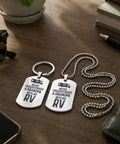 Never Underestimate A Grandpa RV Dog Tag Keychain Matching Set Stainless Steel Two Identical Pendants On Wooden Table