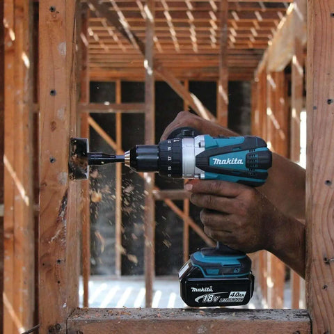 Hard Core Bad Boy 18V Cordless Hammer Driver Drill Kit Featuring 1/2 Inch Chuck And Two Speed Transmission in action drilling wood.