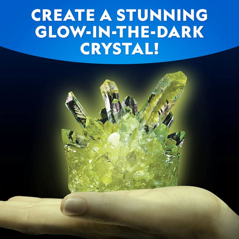 Hand holding a glowing green crystal from Five Types Crystal Growing Kit With Glow In The Dark Crystal Dinosaur Figure Underwater Crystals And Crystal Trees Plus Learning Guide A STEM Science Kit For Kids Totally Fun And Educational.