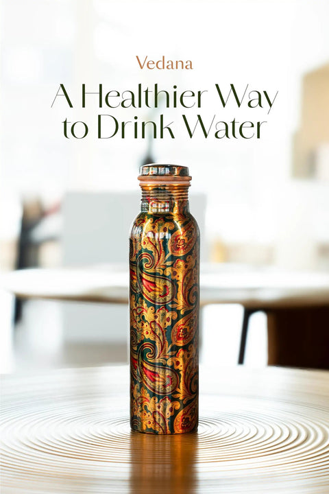 Copper Water Bottle 1 Liter With Ayurvedic Health Benefits displayed on a wooden table in a bright setting.