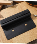 Modern Kitchen Cabinet Foot Pull Handle With Hidden Door Handle For Trash Drawer in black carbon steel, front view on wood surface.