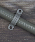 Heavy Duty 12 Piece Pack Of 1/2 Inch Pvc Pipe Straps With No Sweat Wall Mount Setup and Rock Solid Grip for Securing Electrical Conduits and Cables Ultra Durable Quality, showing a gray PVC strap on conduit.