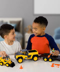 Two children playing with Worksite-Ready Skid Steer And Pickup Crew Set For Kids, 15-Piece Construction Toy Playset With Pickup Truck
