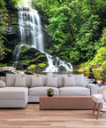 Huge 108 By 75 Inch Cascading Waterfalls In Forest Wall Mural For Bedroom Living Room And Kids Room Non Self Adhesive 5 Piece Set Large Silk Material Wallpaper Decor Easy Install In Five Sections depicting a serene forest waterfall behind a modern sofa.