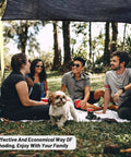 Group of friends and a dog sitting under a 55 Percent Shade Cloth Mesh Tarp With Grommets For Plant Cover 6.5X16.5Ft