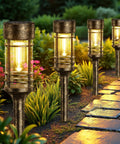 4 Pack Solar Firefly Lights Outdoor Garden Decor with 32 LED swaying iron wire bulbs along a garden pathway at night