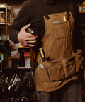 Man wearing Heavy Duty Work Apron With Dedicated Tool Pockets For Easy Access, Ergonomic Design For All Day Comfort, rugged workshop