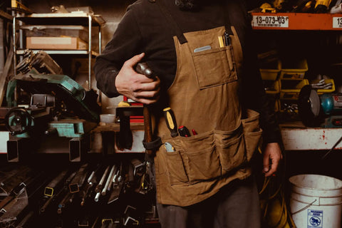 Man wearing Heavy Duty Work Apron With Dedicated Tool Pockets For Easy Access, Ergonomic Design For All Day Comfort, rugged workshop