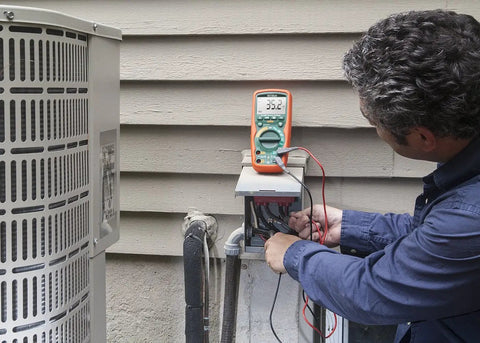 Technician using True RMS Heavy Duty Industrial Multimeter with IP67 Waterproof and 6 Foot Drop Protection CAT IV 1000V UL Listed outdoors.