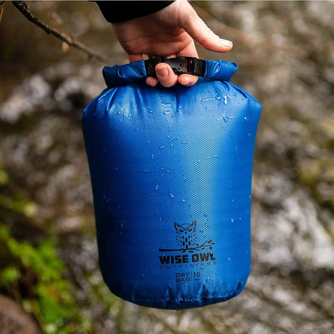 Three Pack Waterproof Dry Bags Set 5L 10L 20L Lightweight Airtight Floating Gear Organizer For Kayaking Beach Travel Boating And Hiking Blue Ripstop Nylon Adventure Ready held by hand