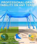 Pop Up Beach Canopy Sun Shelter With UPF Fifty And Ten By Ten Foot Coverage, Windproof Frame With Eight Sandbags And Stakes, shown at the beach with stabilizing features.