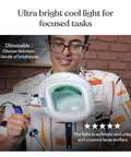 Person using XL Pro Grade Magnifying Desk Lamp With Clamp And LED Light For Crafts Reading And Close Work, smiling while working.