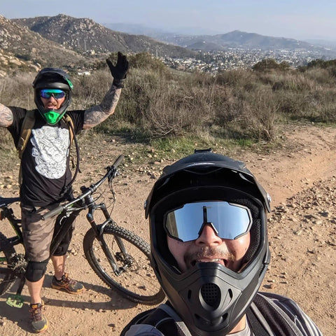 Cyclists wearing polarized sports sunglasses with five interchangeable lenses for guys and gals, ultralight 19.2g on a trail.