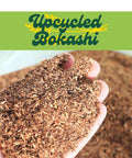 Hand holding upcycled grains of Upcycled Bokashi Compost Starter for Kitchen Bins from 100 Percent Upcycled Grains Dry Bokashi Bran.