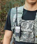 Person wearing tactical vest with Your Go To Dual Band Ham Radio Antenna For 136-174MHz And 400-470MHz on walkie talkie.
