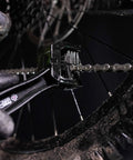 Go To Road Gravel MTB Bicycle Chain Cleaning Brush Three Sided Tool With Long End being used on a dirty bike chain