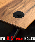 2.5 Inch Plastic Cable Grommet installed on wooden desk, fits 60mm hole, for wire management and cord organization.