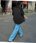 Yo Drummer Grab This Flat Out Tough Oxford Carrier Bag For Snare And Practice Pads worn by a person walking on a street.