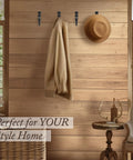 Heavy Duty Kickass Cast Iron Wall Hooks 5 Pack Handmade Blacksmith J Hooks with a coat and hat on a wooden wall.