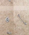 Eva Brushed Nickel Sleek Posi Temp Tub And Shower Trim Kit with showerhead, shower arm, tub spout, and lever handle on tiled wall