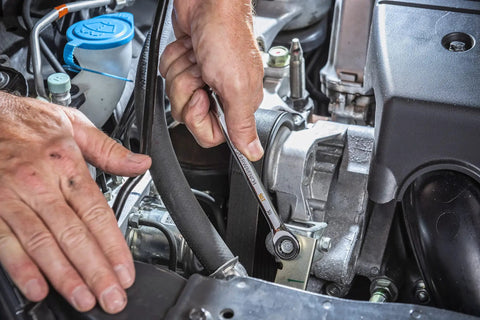 Mechanic using a 10mm 4 Degree Swing Arch 12 Point Ratcheting Combination Wrench With Off Corner Loading on an engine bolt