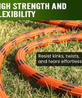 Orange garden hose with braided exterior lying on grass