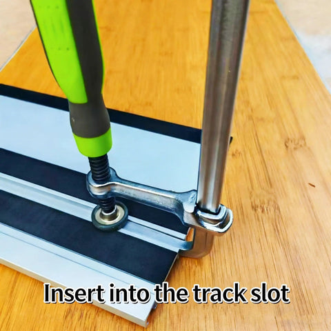 Rock Solid Kickass Hold Down Clamps For Woodworking Track Saws And T Track Jigs Precision Dovetail Shop Fixture Heavy Duty Tabletop Tool With Killer Deep Throat Depth And Sweet Four Point Seven Inch Clamp Range, inserting clamp into track slot.