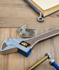 Close-up of stainless steel refrigerator shelf clips 6 pack must have smooth surface shelf support hooks on wooden table with tools.