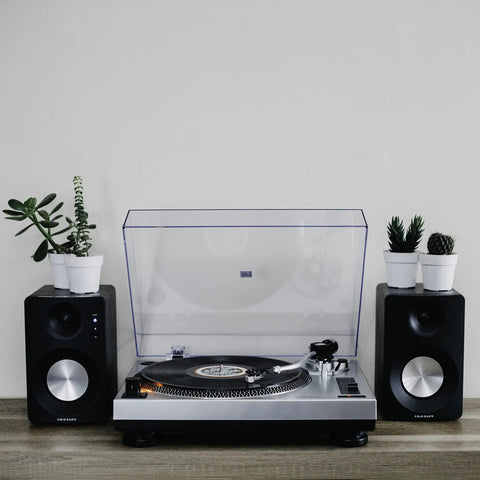 Crosley C100A Silver Belt Drive Turntable With Aluminum Tonearm Pitch Control For 33 And 45 Rpm Vinyl Records on a stylish audio setup.
