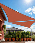 Rust Red Triangle Shade Sail 24 Ft By 24 Ft By 33.9 Ft UV Blocking Breathable Sun Shade Canopy installed on patio