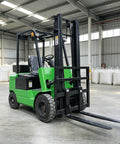 Electric Cargo Forklift For Warehouse Operations Heavy Duty Battery Powered Material Handling Workhorse For Efficient Freight Movement In Industrial Warehouses green electric forklift with twin forks in warehouse