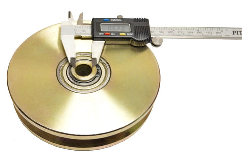 Heavy Duty Six Inch V Groove Gate Roller With Double Ball Bearings showing measurement with caliper for load capacity verification.