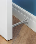 Ravinte door stopper, satin nickel, spring-style, installed through baseboard at bottom of door.