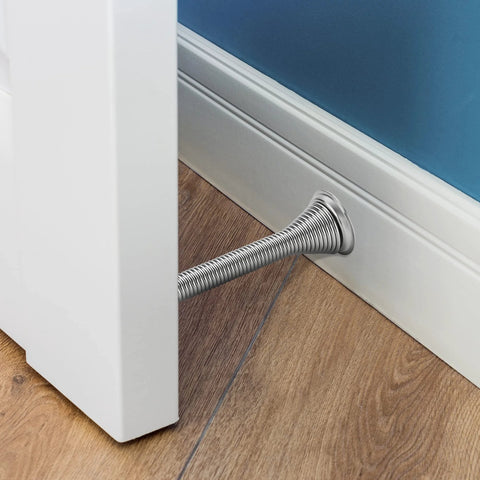 Ravinte door stopper, satin nickel, spring-style, installed through baseboard at bottom of door.