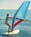 Person using 4.2 Square Meters Inflatable Wing Foil Sail For Wing Foiling, SUP And Kitesurfing on the ocean, clear sky background