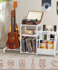 Retro Vinyl Record Player Stand With Adjustable Guitar Holder For Acoustic Or Electric Bass, Huge 150 Album Storage Space, Side Table With Magazine Rack And White Turntable Platform, Cool Vintage Shelf showcasing guitars and vinyl records.