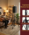 Musician using Universal Speaker Stand Tripod With Heavy Duty Build Adjustable Height From 40 To 71 Inches 35mm Insert in studio