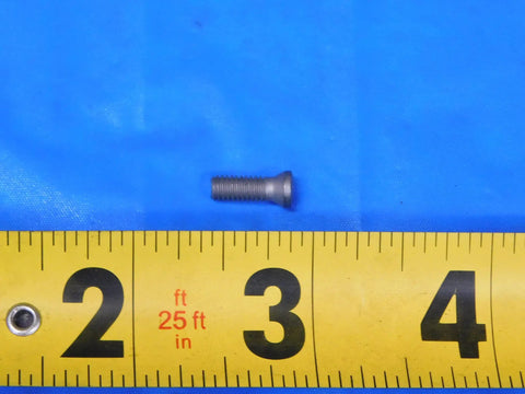 Close-up of a Torx screw on a ruler showing size, part of Straight Up Heavy Duty Replacement Torx Screw Hardware And T A Spade Drill Holder Precision Industrial Machining Tooling Hardcore Workhorse Setup Built Tough For Serious Machine Shops Today.