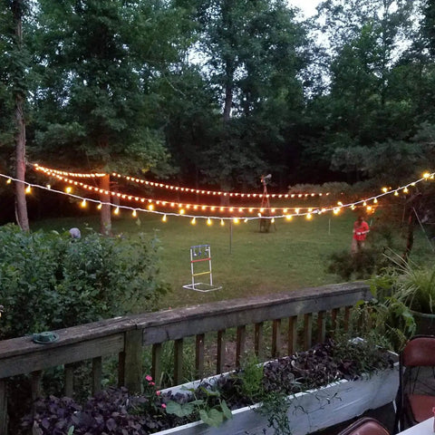 Outdoor patio with string lights featuring 25 Pack Edison Style Replacement Light Bulbs 7-Watt E12 Candelabra Base.