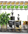 Large Capacity K Cup Holder And Coffee Pod Organizer For Home Office And Kitchen Counter Storage Holds 28 Pods On Top Plus Space For Extra Cups And Accessories Keeps Your Coffee Bar Neat And Ready For Busy Mornings, holding coffee pods, syrup bottles, and a plant.