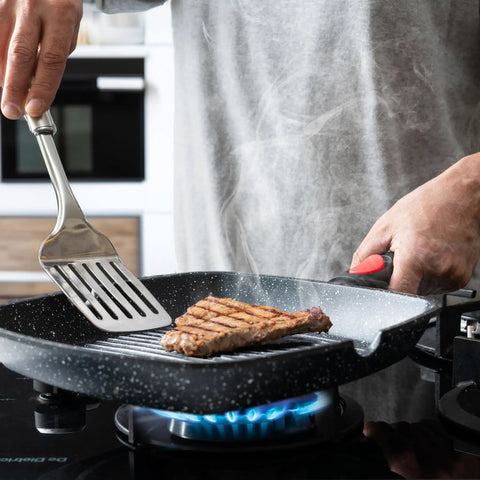 Man grilling steak on Square Indoor Grill Pan With Removable Handle For Even Heating Meat And Veggies, 11 Inch Nonstick Griddle Skillet, RV Die Cast Aluminum Stove Top Grill Pan, Detachable Handle, Oven Safe Up To 480 Degrees
