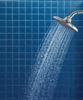 Velocity Chrome Two-Function Rain Shower Head With Immersion Technology, 8-Inch Wide Spray in a blue tiled bathroom