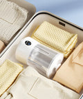 Portable Mini Sock Washing Machine Cordless Rechargeable Battery Power No Sweat Quick Clean Spot-On Stain Removal in a drawer with folded socks.