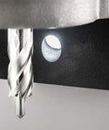CS Unitec MAB 155PRO magnetic drill; close-up of silver twist drill beside a circular hole in a black metal base