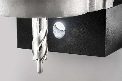 CS Unitec MAB 155PRO magnetic drill; close-up of silver twist drill beside a circular hole in a black metal base