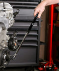 Mechanic using Extendable 1/2 Inch Drive Black Breaker Bar With Twist Lock Telescoping 16 To 24 Inch Reach on engine bolt