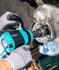 Tough As Nails Twin Turbo Air Impact Wrench With Compact Low Vibration Grip For Tightly Packed Engine Bays And Heavy Duty Truck Maintenance in action on a vehicle's wheel hub.
